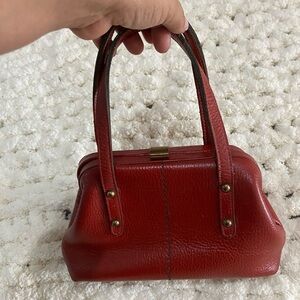Vintage 
Red Mini Bag with Glossy Finish and Structured Design